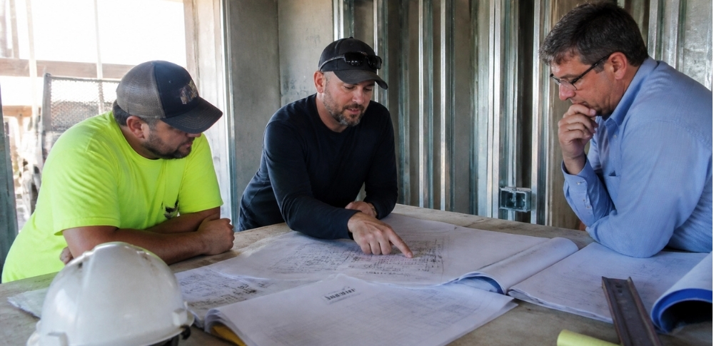 General contractor and project team reviewing building plans in Asheville, NC