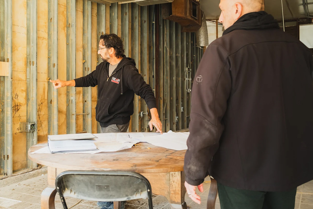 Why Experience Matters in Construction Project Management 1 Two men talking at a construction site
